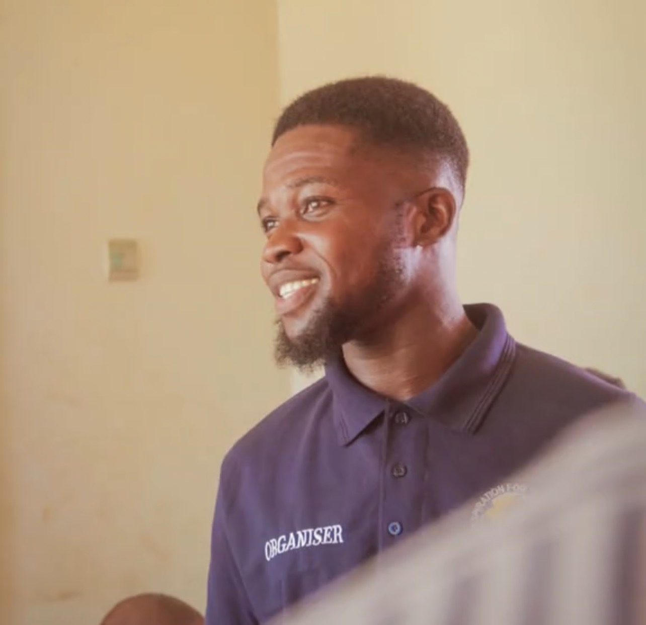 IWF Organizer in a branded navy polo shirt